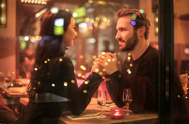 A couple enjoying a meal together at a restaurant table.