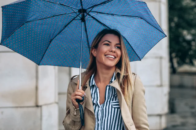 A woman carry an umbrella in the rain