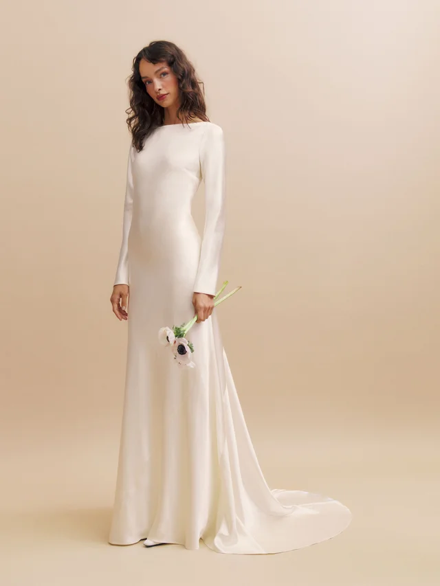 Elegant silk wedding dress with boat neckline and open back, perfect for modern understated brides