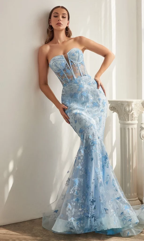A woman in a strapless blue butterfly print corset prom dress with mermaid silhouette.