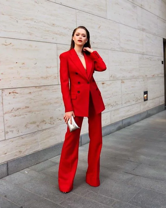 a woman in a bold red power suit