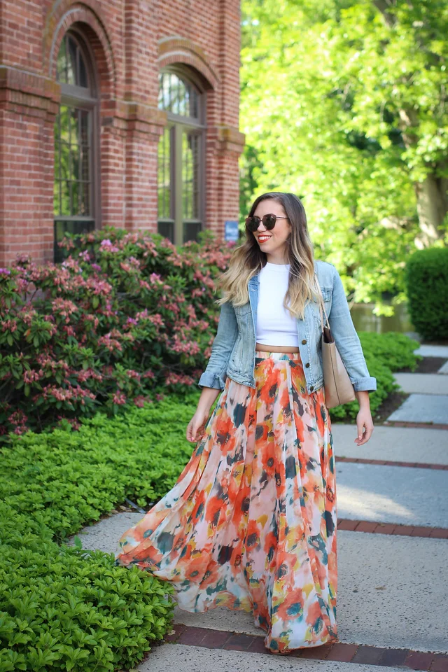 a woman wearing a floral skirt and sunglasses